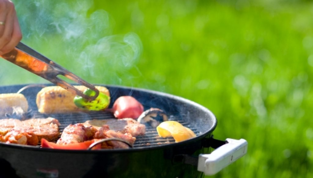 Grilling at summer weekend. Fresh meat and vegetables preparing on grill.